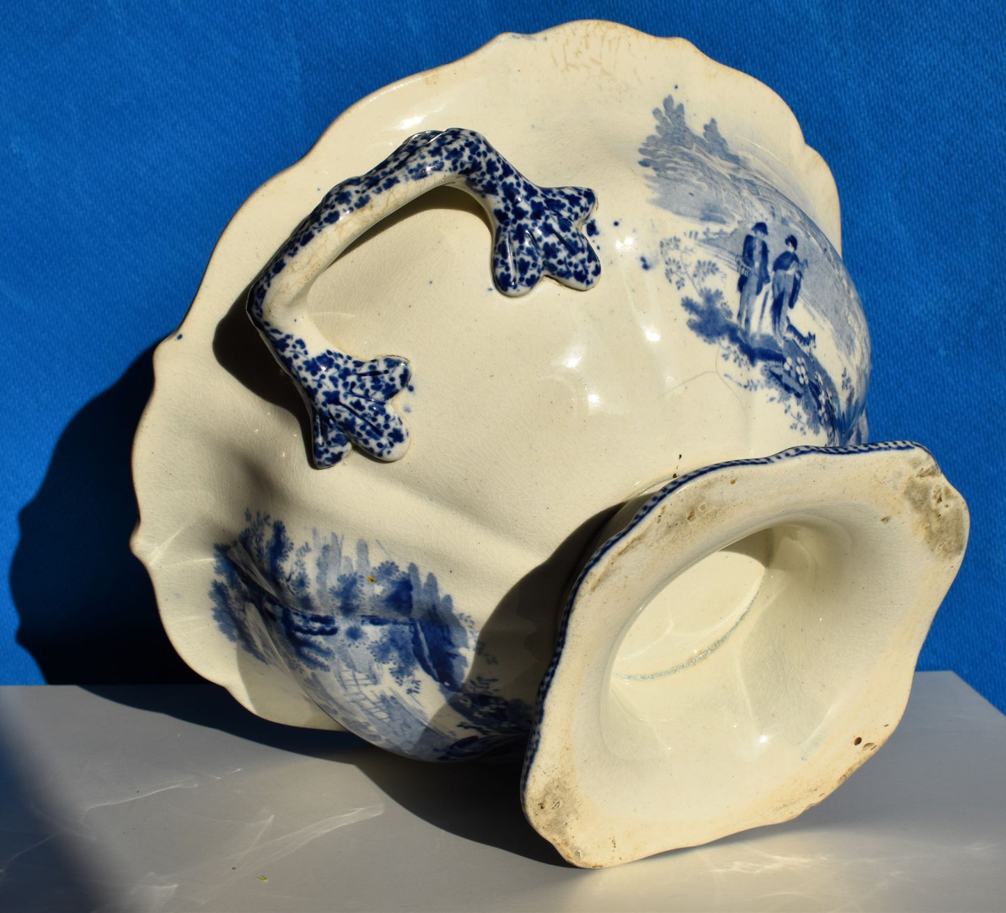 The base of the bowl is blank with no makers mark. The handles are decorated with blue flowers