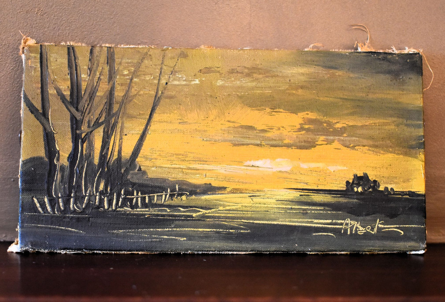 Painting of a landscape with trees and a sunset sky on a wooden panel.