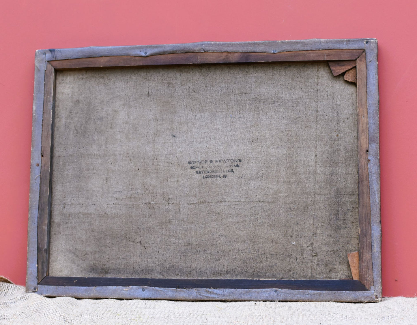 Wooden picture frame with a textured back on a red background