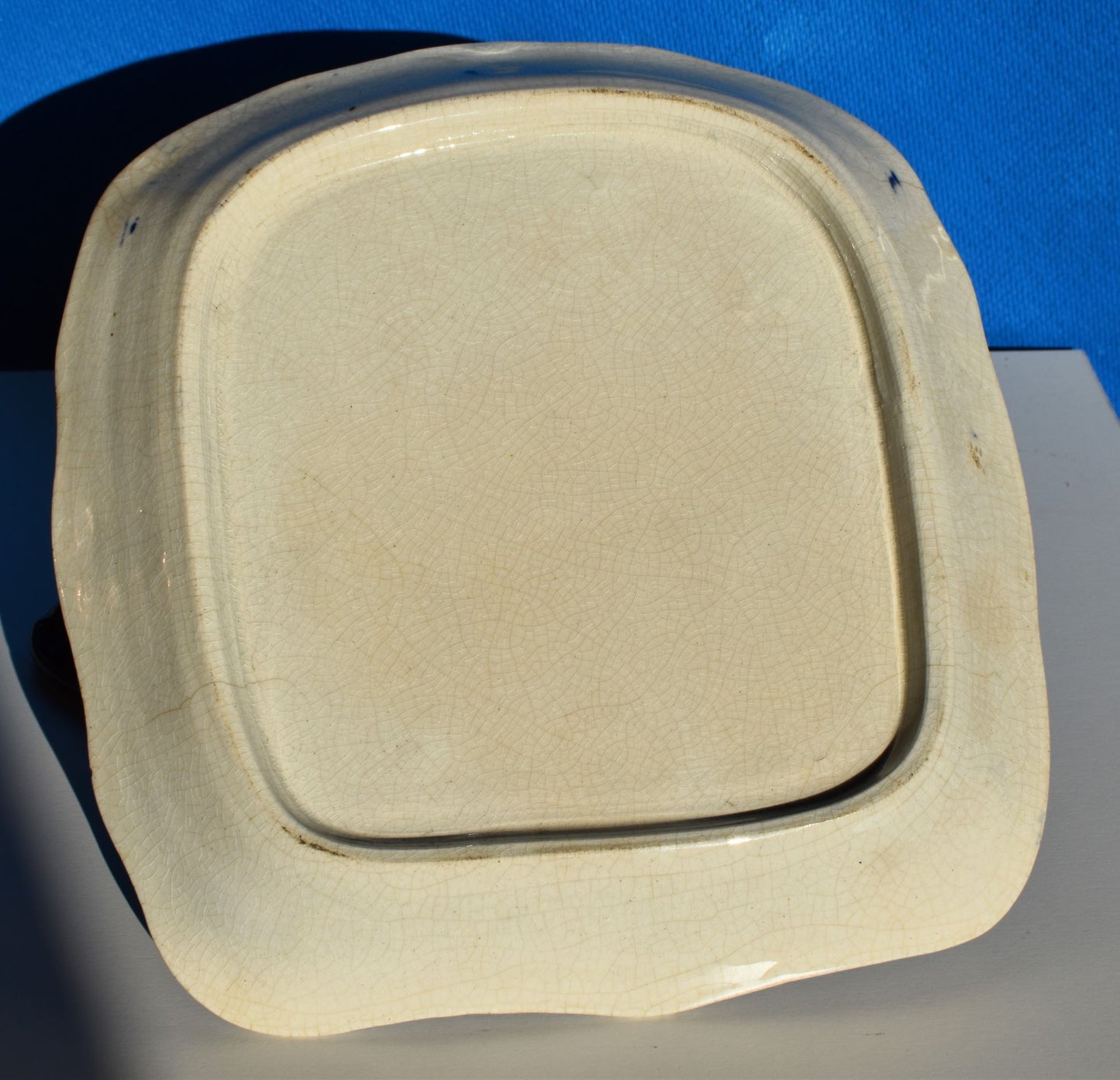 The bottom of the dish shows no maker's mark. Some grazing of the glaze.