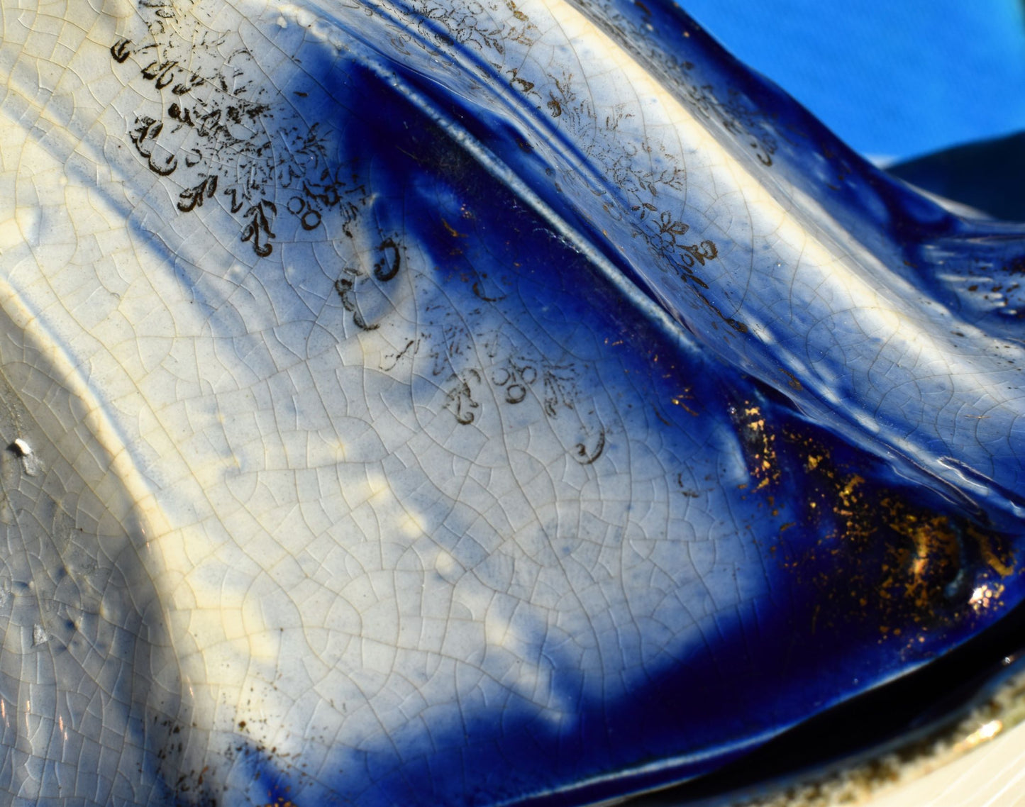 Close up shows gold gilding on the blue lid, plus some crazing of the glaze