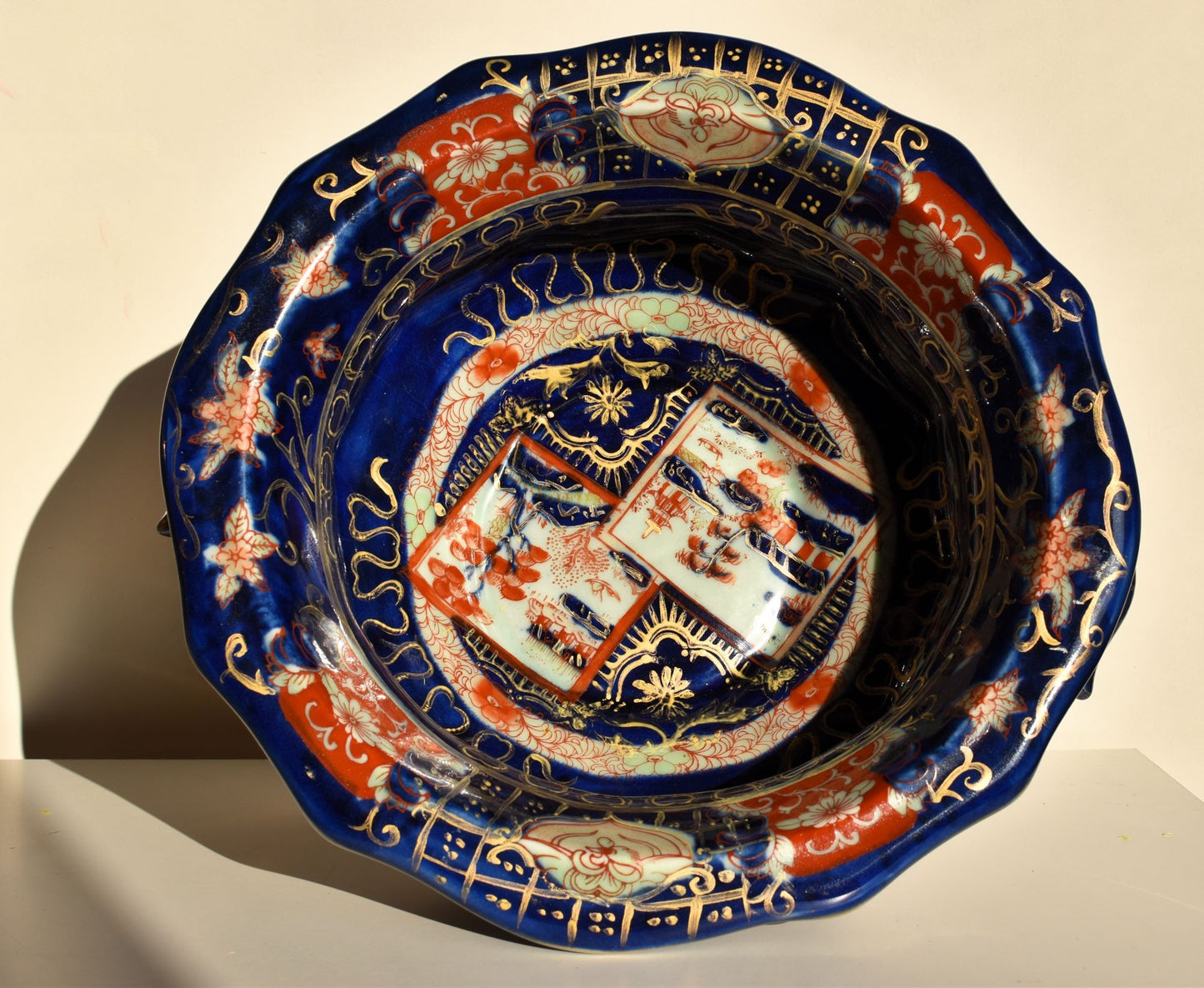 The inside of the blue bowl is heavily decorated in orange and gold