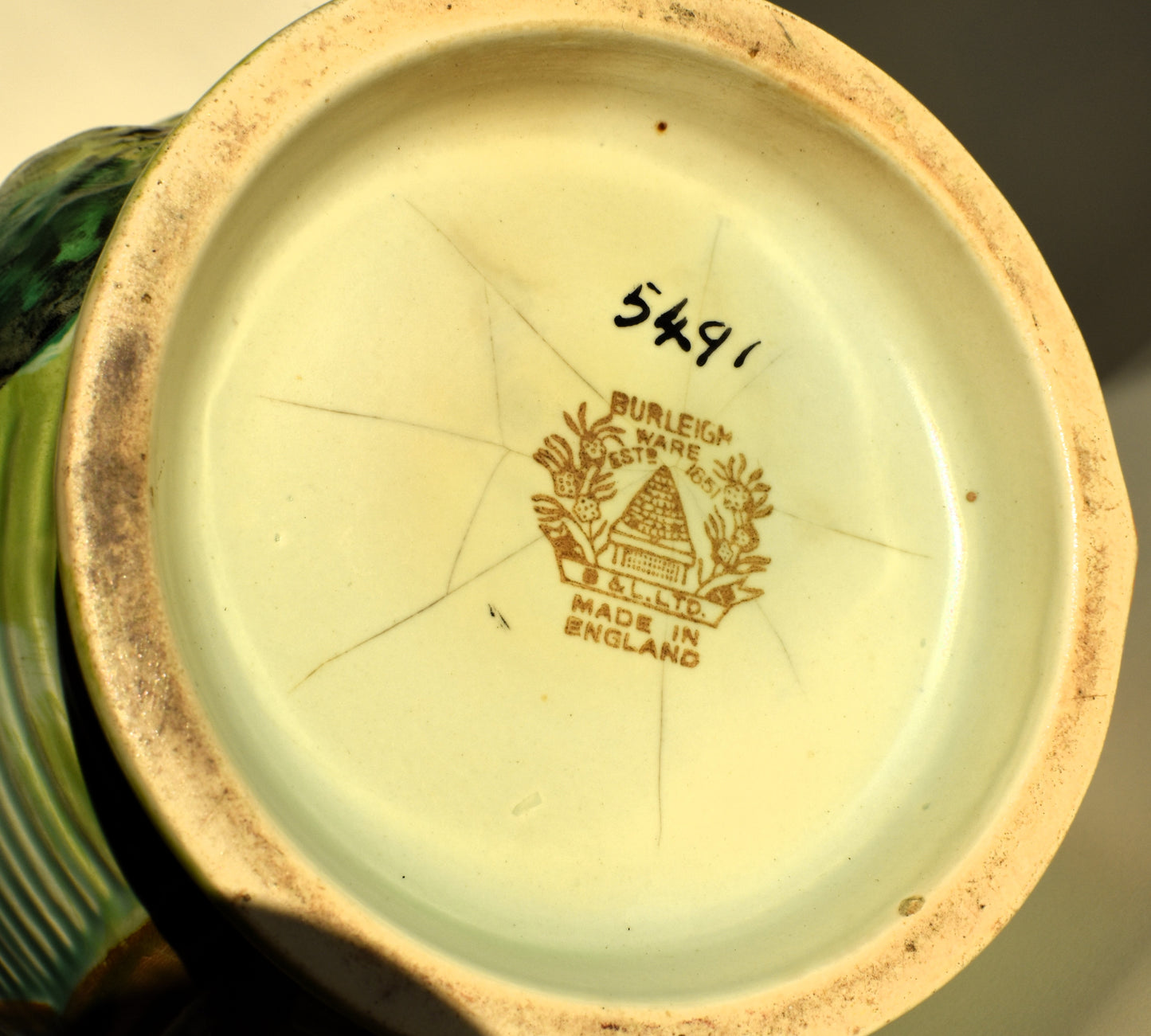 The base of the vase shows the makers mark which says 'Burleigh ware, made in England' with the hand painted number 5491 to show someone painted the glaze by hand.