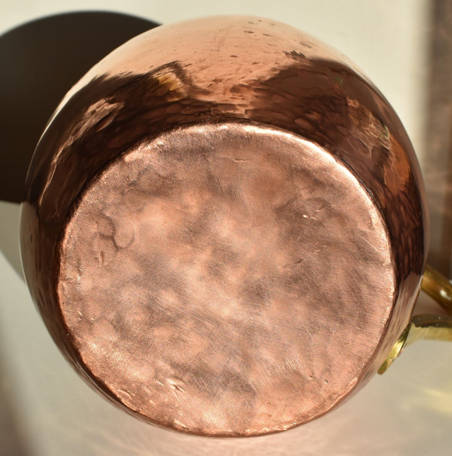 showing the shiny copper base of the large jug