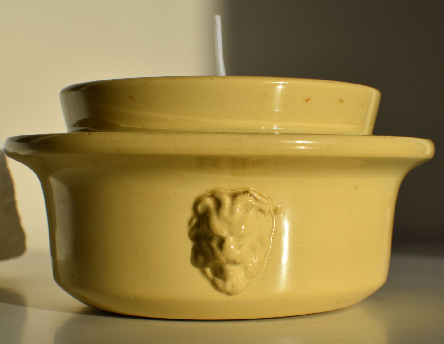 The side of the pot has raised faces