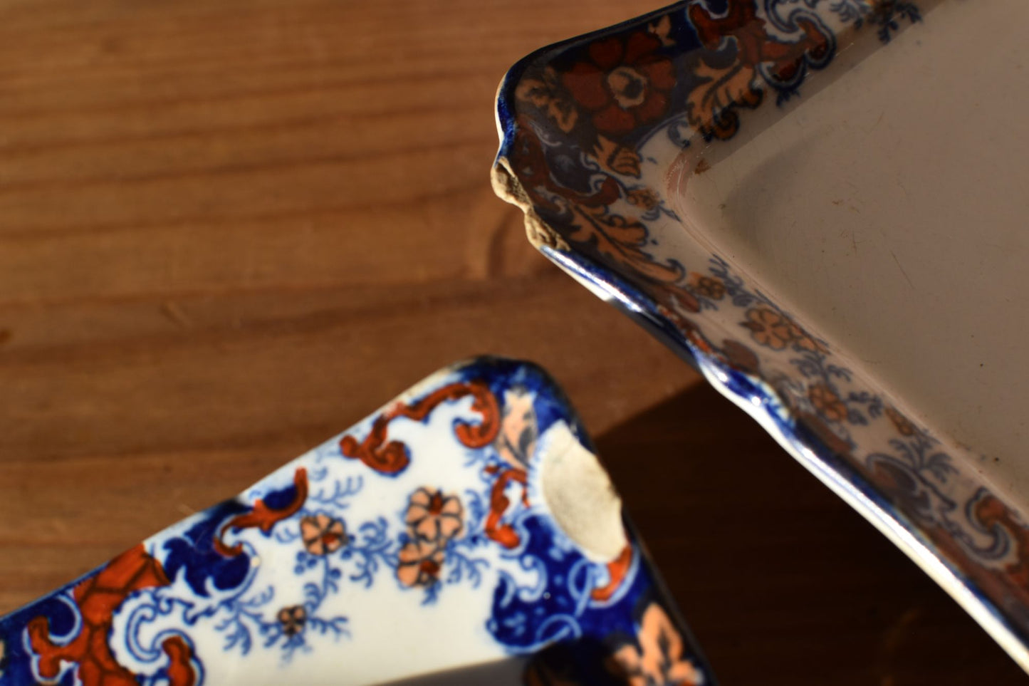 the corner of a floral dish is slightly chipped