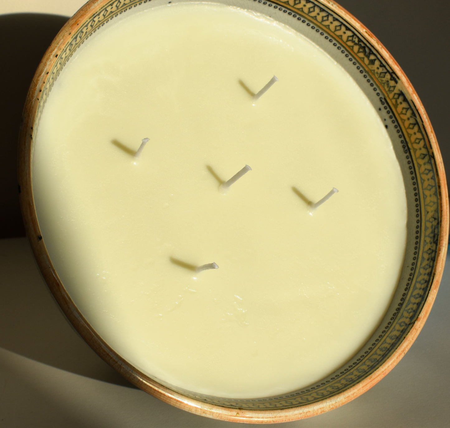 A bowl is filled with white scented soy wax and 5 wicks to create a large candle