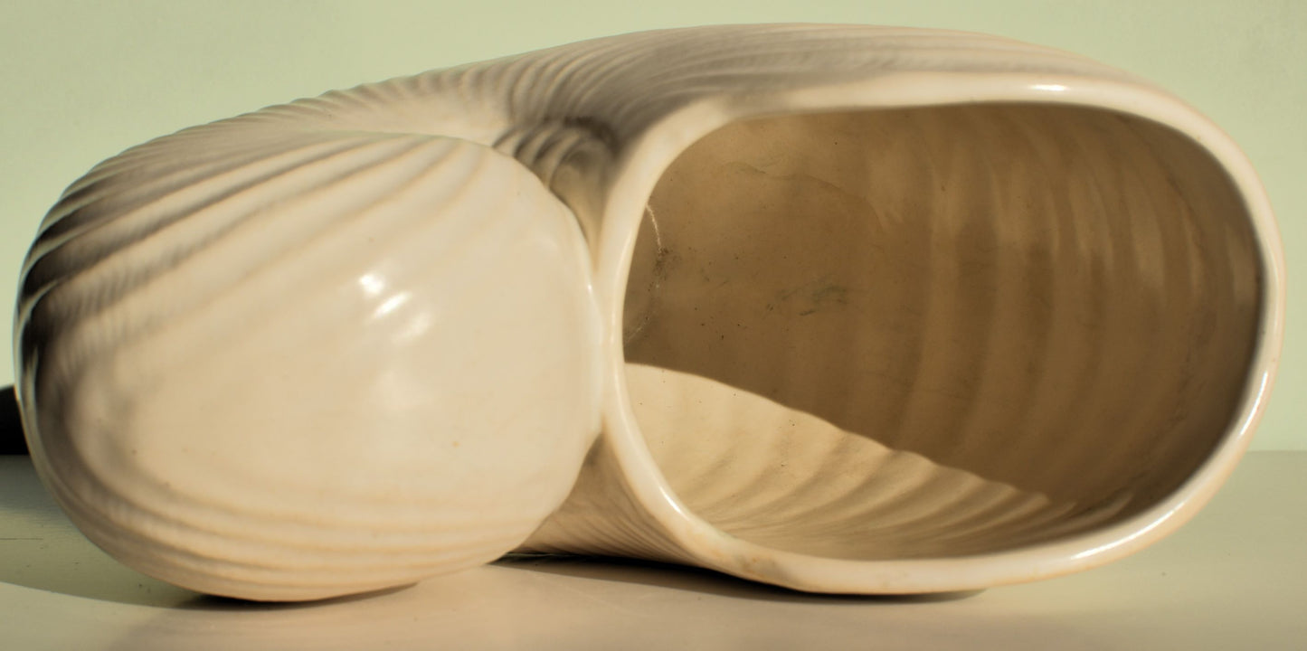The vase on its side shows the inside is the same off white colour