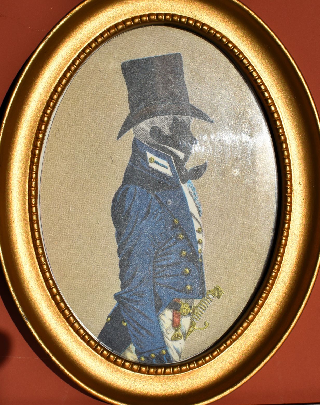 the left painting has a silhouette in a blue military coat, large black hat, all over gold details including buttons and sword handle