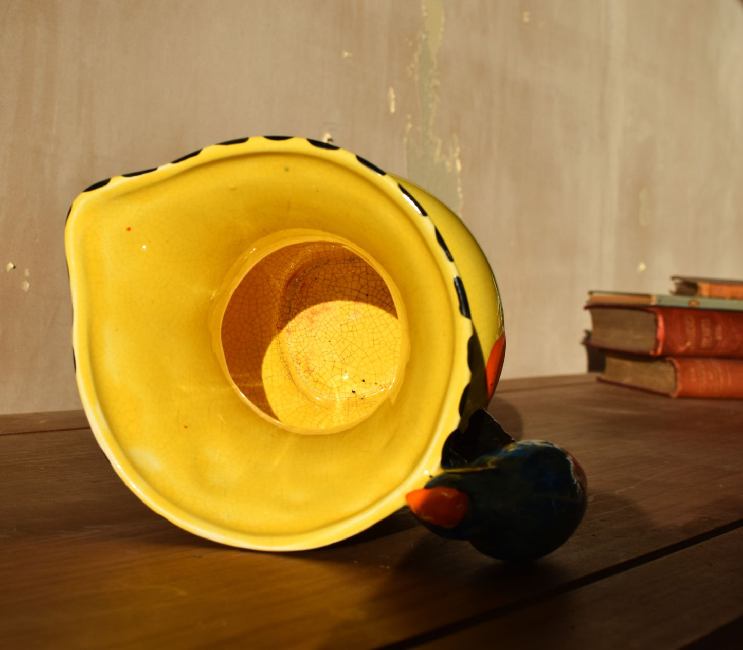 the yellow inside of a jug laying on a wooden surface