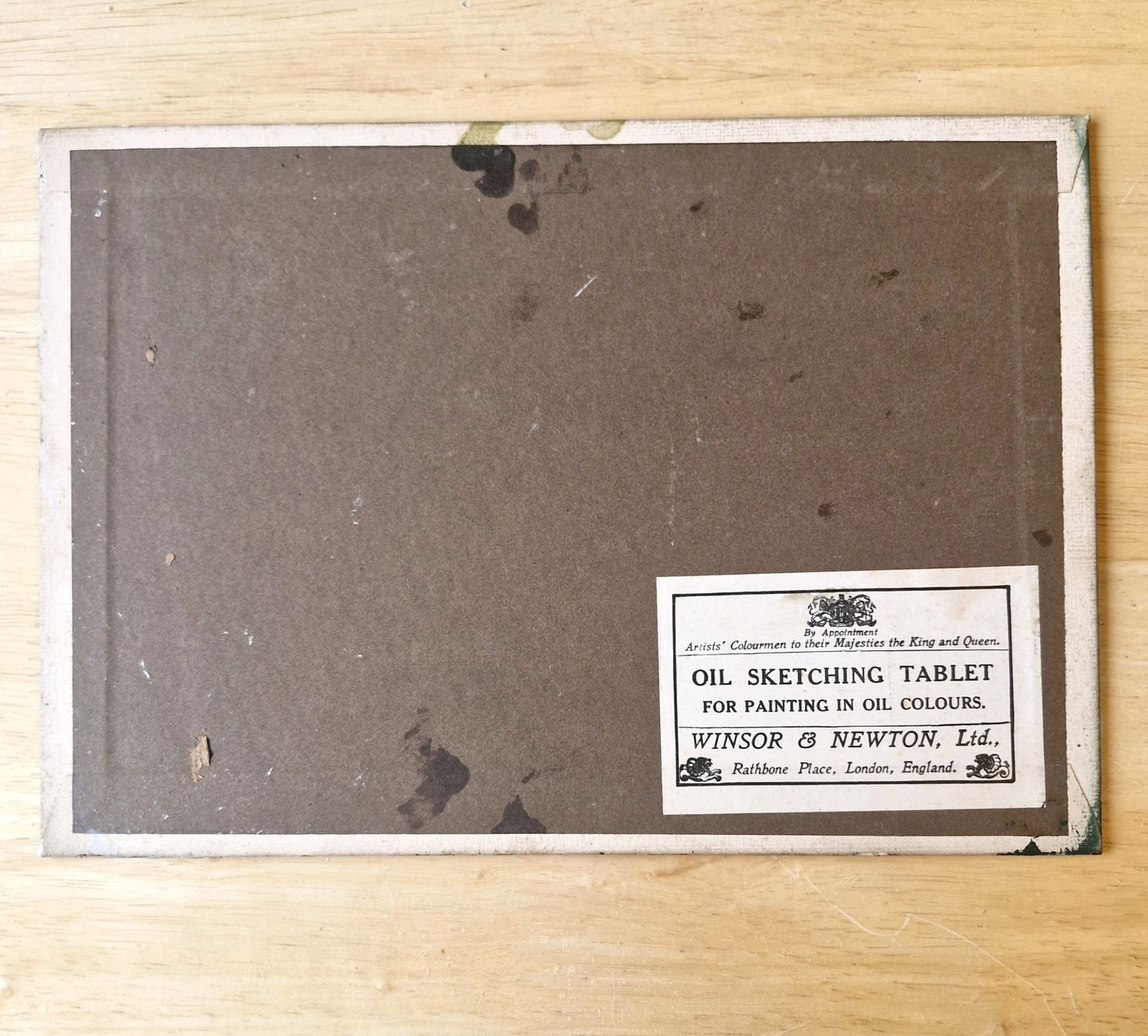 Oil sketching tablet with a label on a wooden surface