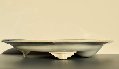 Ceramic plate with a decorative base on a beige background