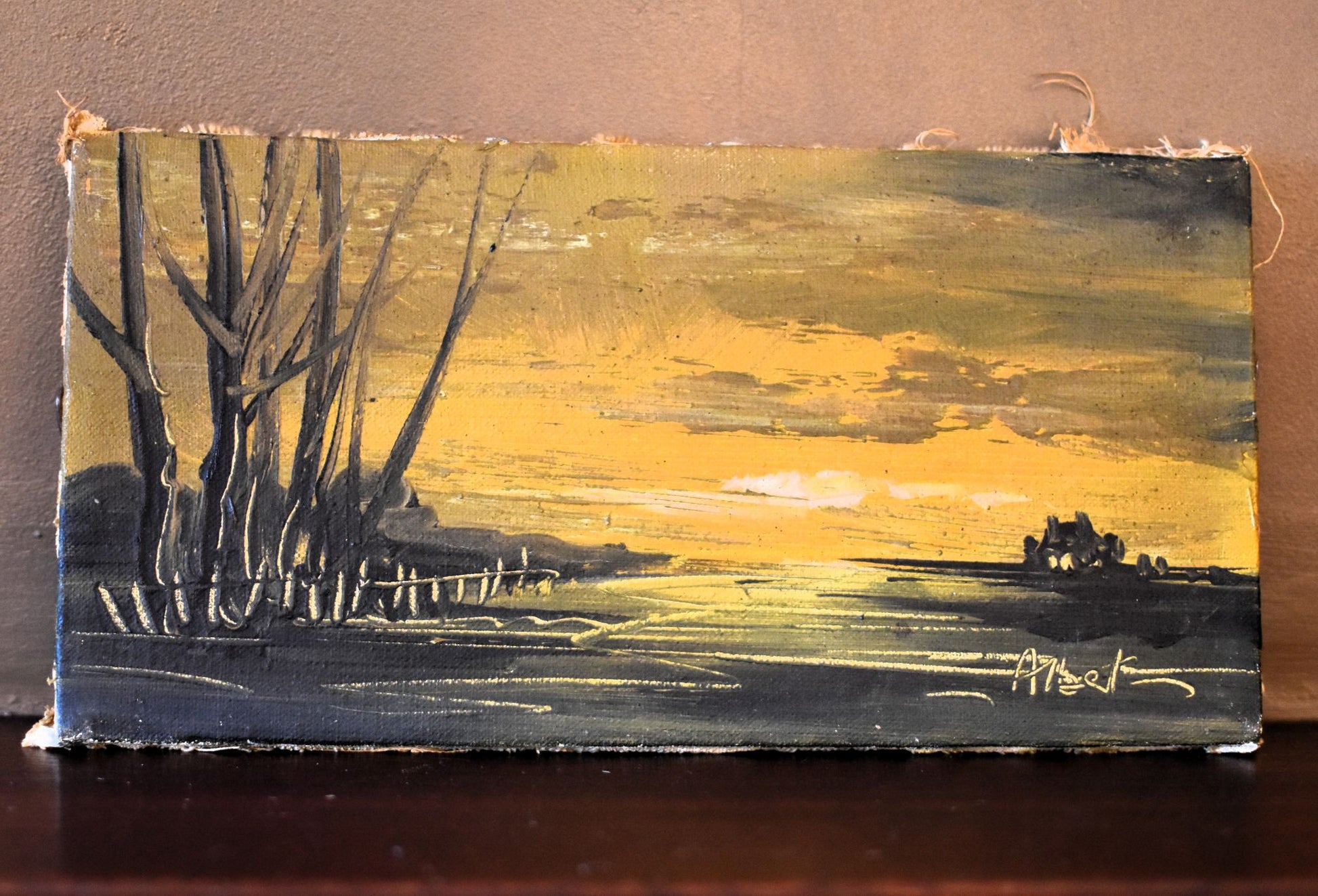 Painting of a landscape with trees and a sunset sky on a wooden panel.
