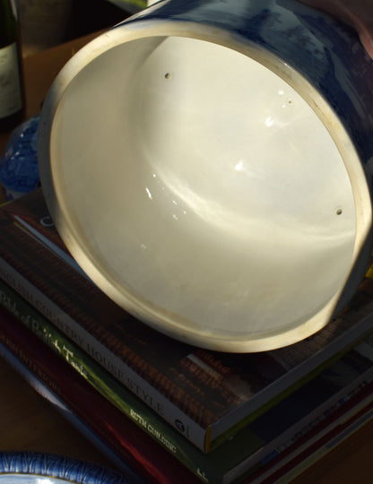 Close-up of a white ceramic bowl on top of books