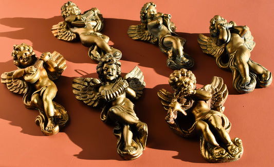 Gold angel figurines on a red background