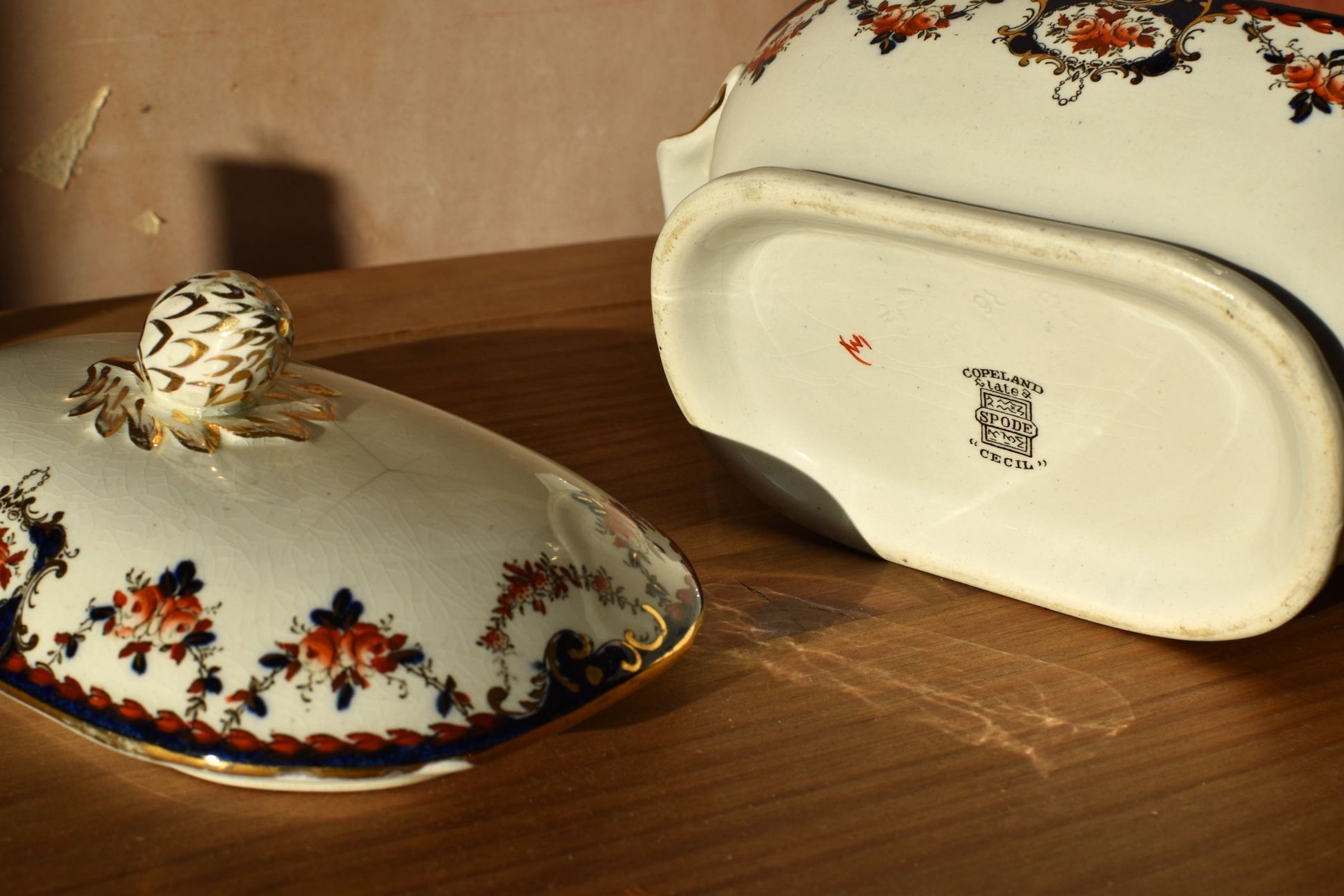 Decorative ceramic dish with floral patterns on a wooden surface