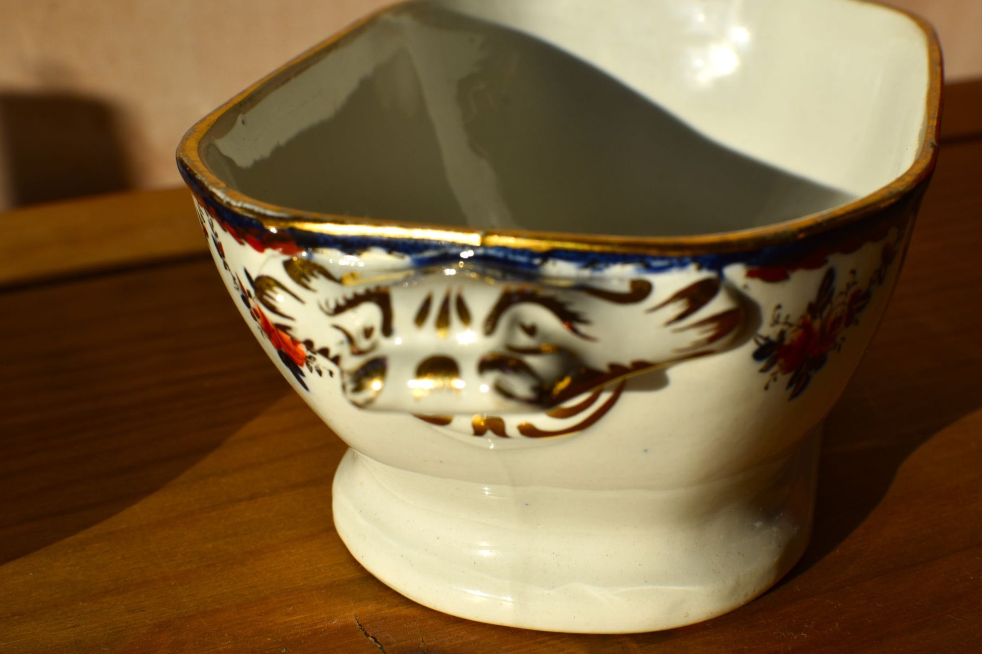 Decorative ceramic bowl with floral patterns on a wooden surface
