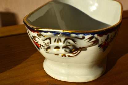 Decorative ceramic bowl with floral patterns on a wooden surface