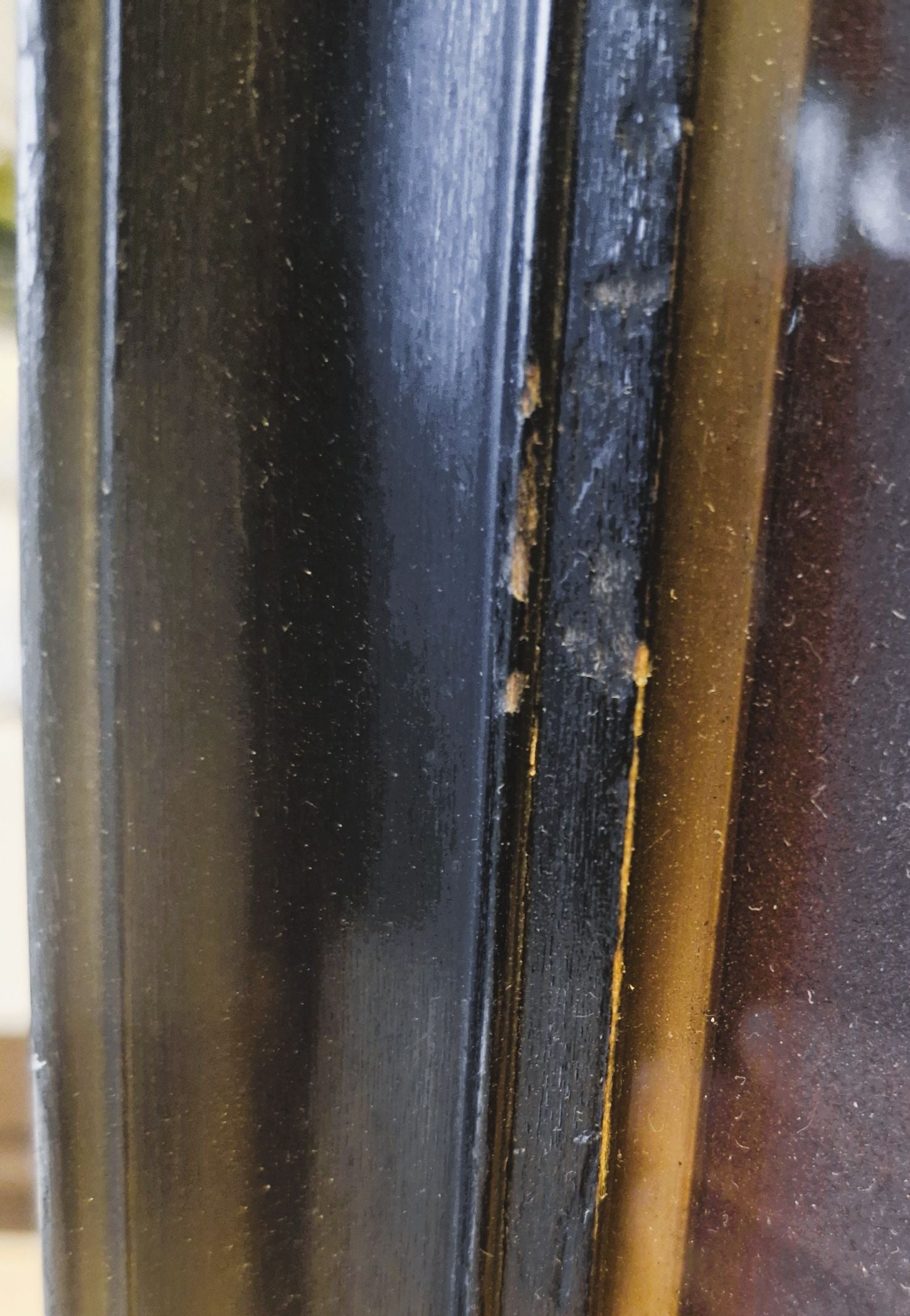 Close-up of a black and brown object with visible wear and tear.