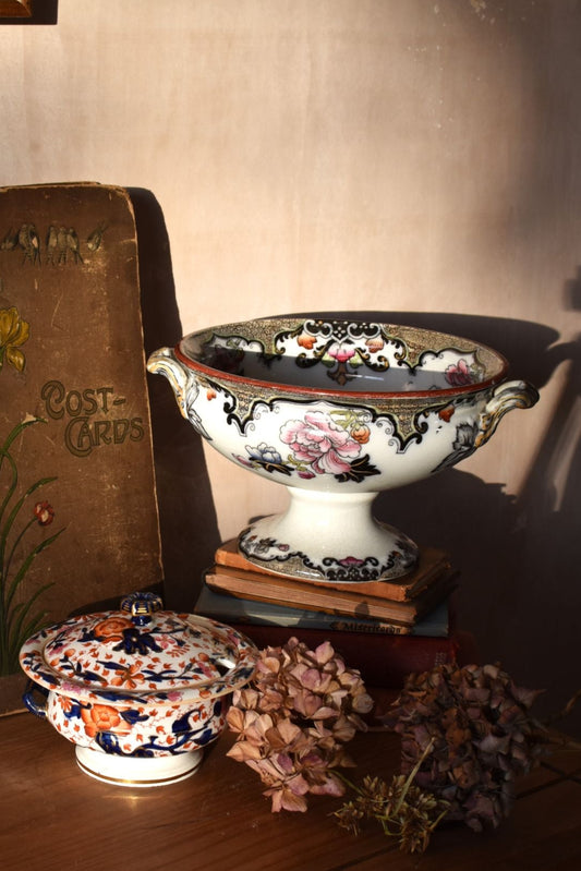 Decorative ceramic items on a wooden surface with a book titled 'Post Cards'.