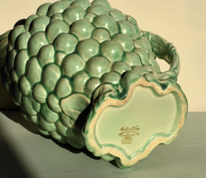 Green ceramic pineapple-shaped vase with 'Burleighware' branding on a plain background