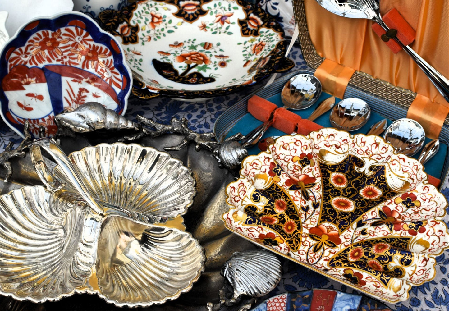 Collection of decorative ceramic plates with intricate designs on a textured surface.