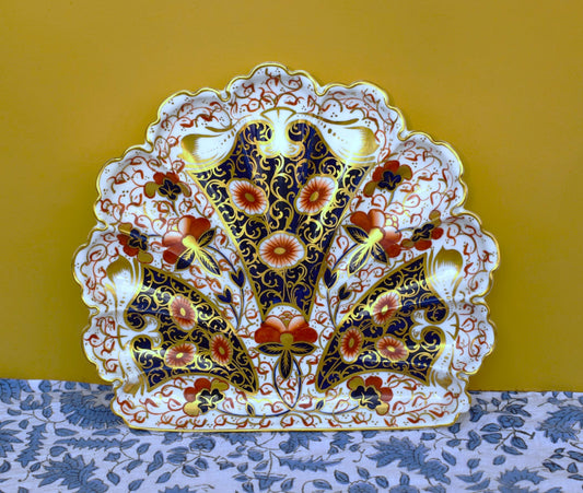 Decorative plate with intricate floral design on a yellow background