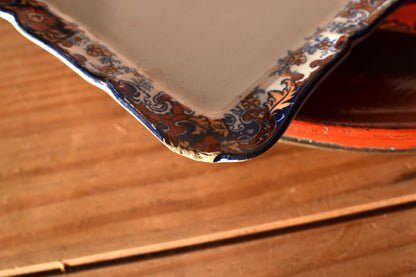The corner of a floral dish is slightly chipped