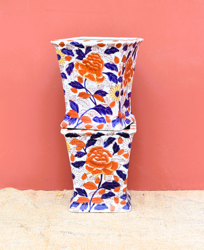 Decorative vase with floral patterns on a peach background