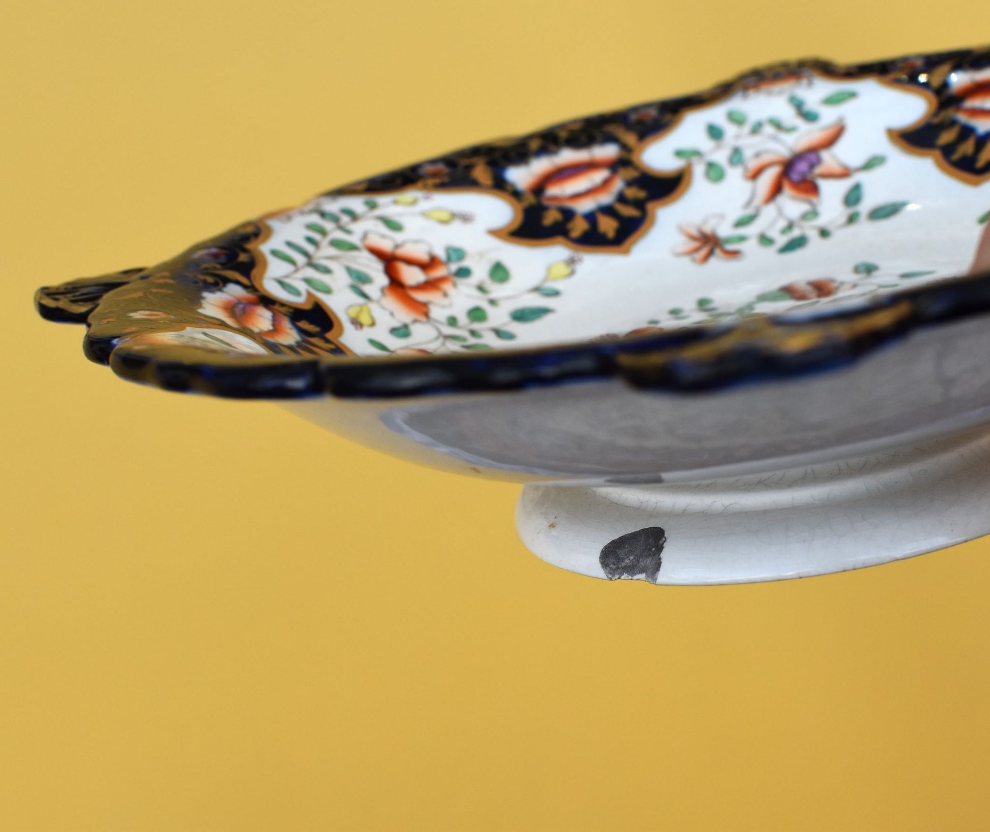 Decorative ceramic plate with floral patterns on a yellow background