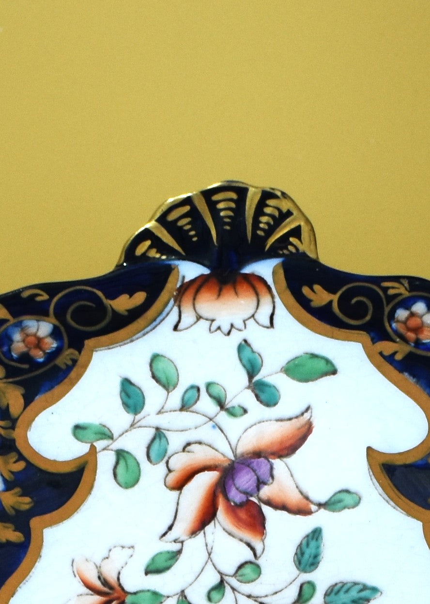 Decorative ceramic plate with floral design on a gold background