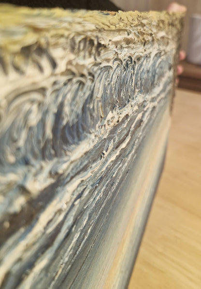 Close-up of a textured surface with brush strokes on a wooden table.
