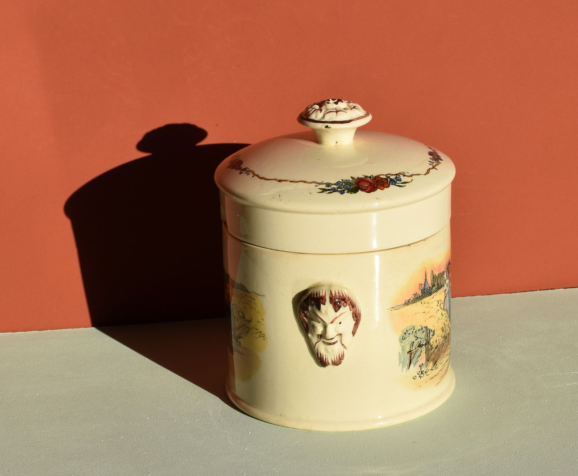 Decorative ceramic jar with artistic designs on a plain background