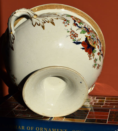 Decorative ceramic vase with floral and butterfly design on a red background
