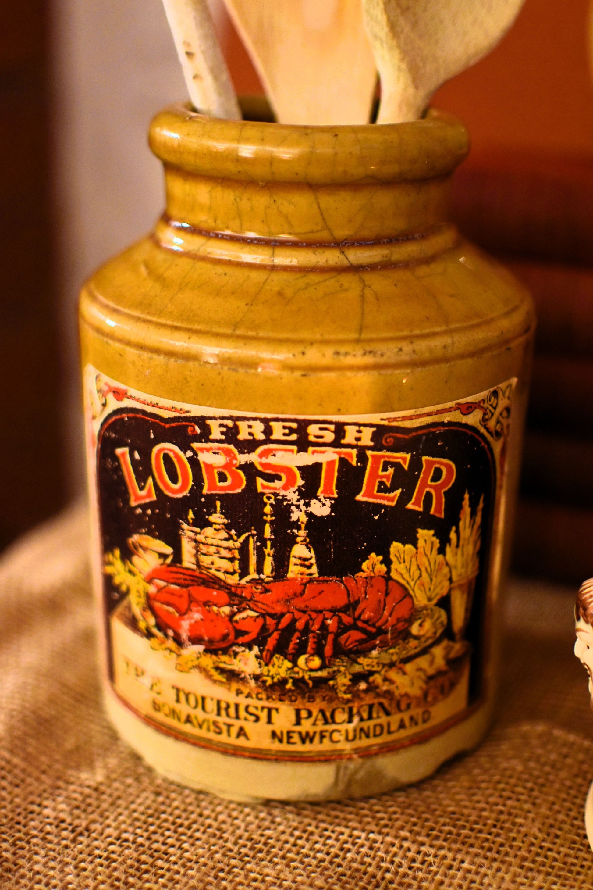 Vintage-style bottle labeled 'Fresh Lobster' on a textured surface