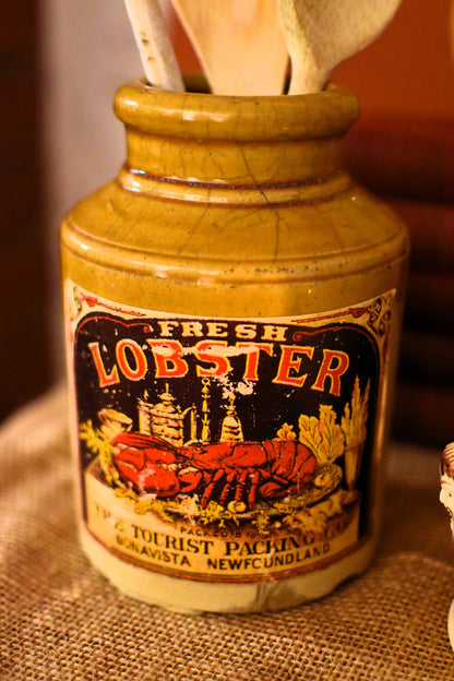 Vintage-style bottle labeled 'Fresh Lobster' on a textured surface