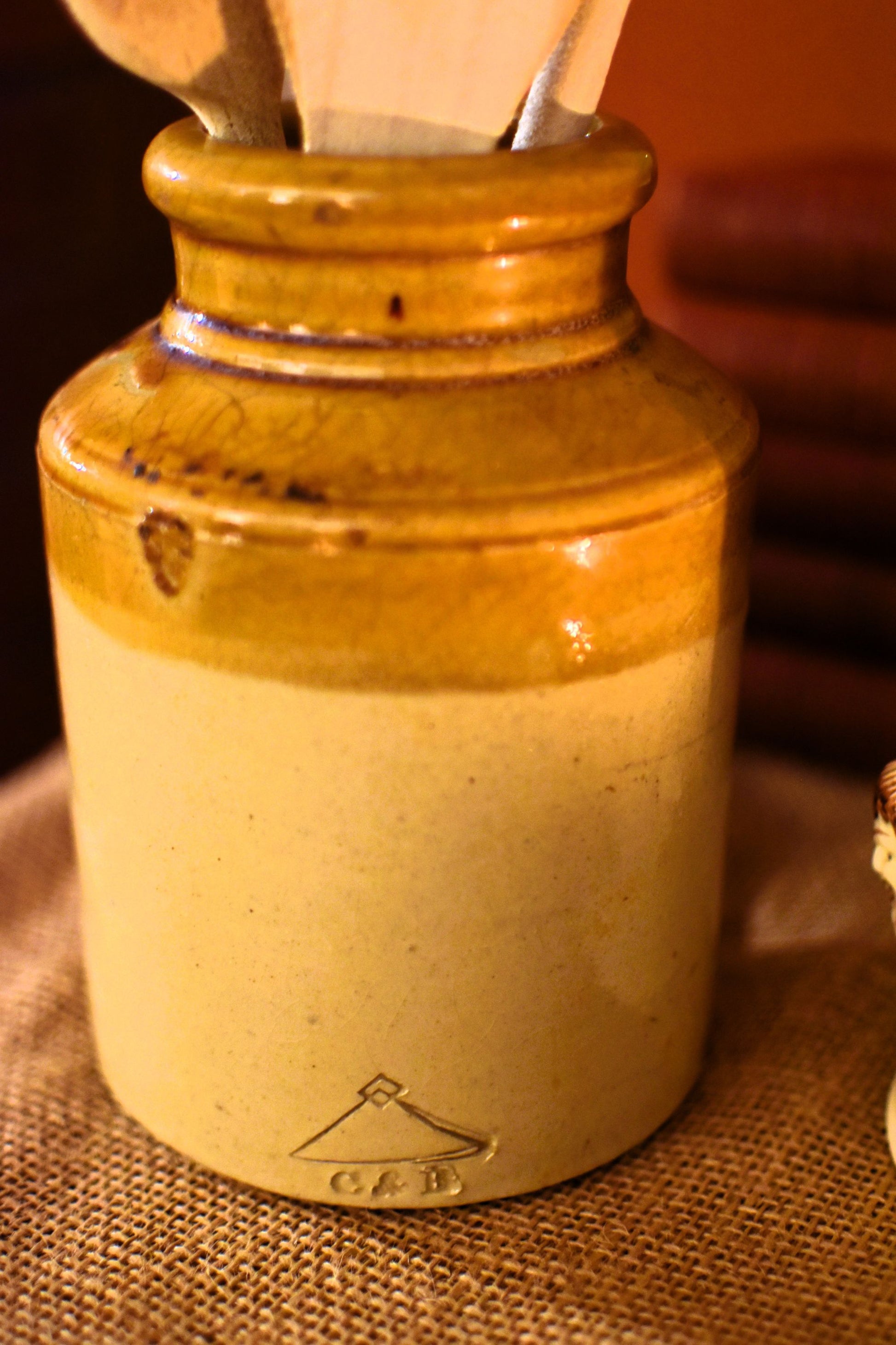 Ceramic jar with wooden spoon on a textured surface