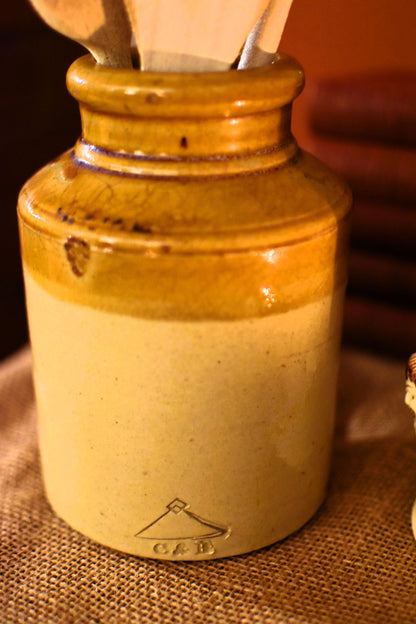 Ceramic jar with wooden spoon on a textured surface