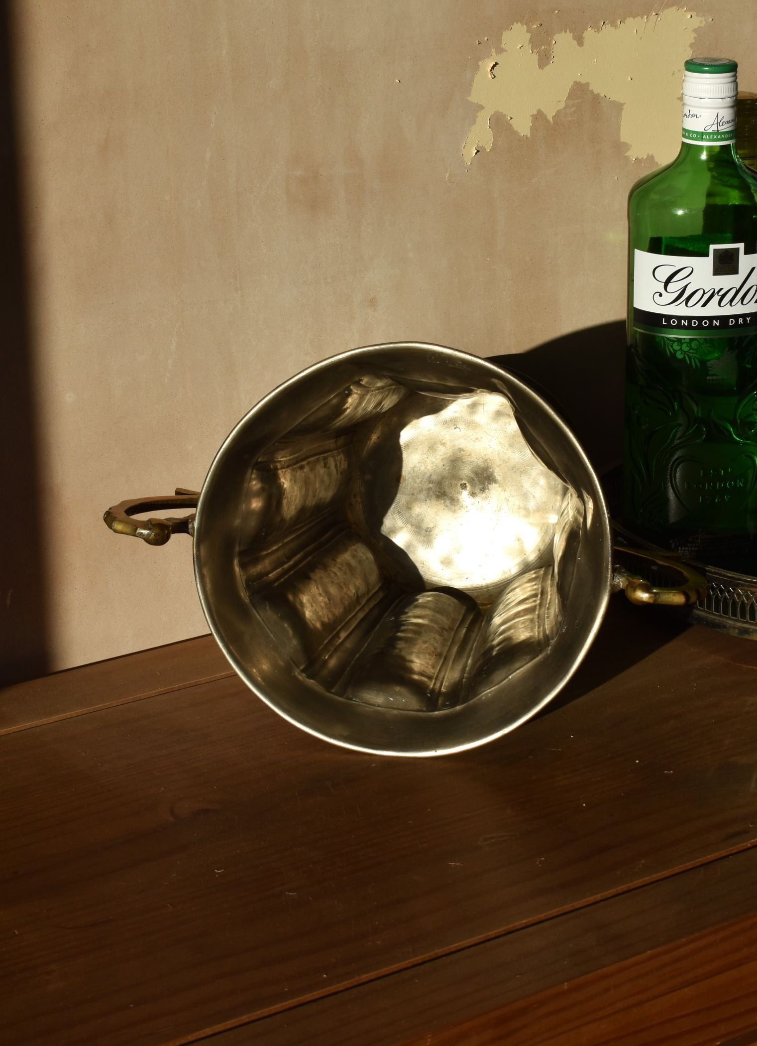 the inside of a silver ice bucket is plain and clean