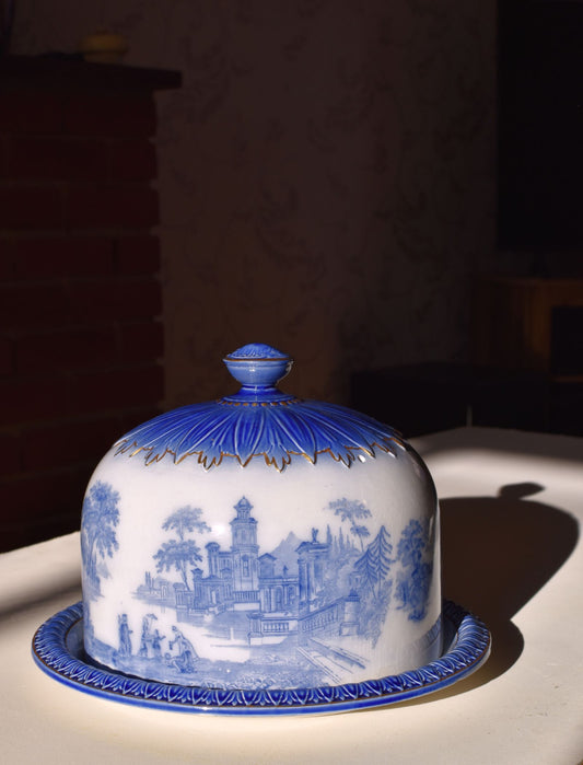 Blue and white ceramic covered dish with intricate designs on a dark background
