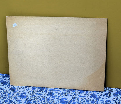 Large cardboard frame on a floral-patterned surface with a green background