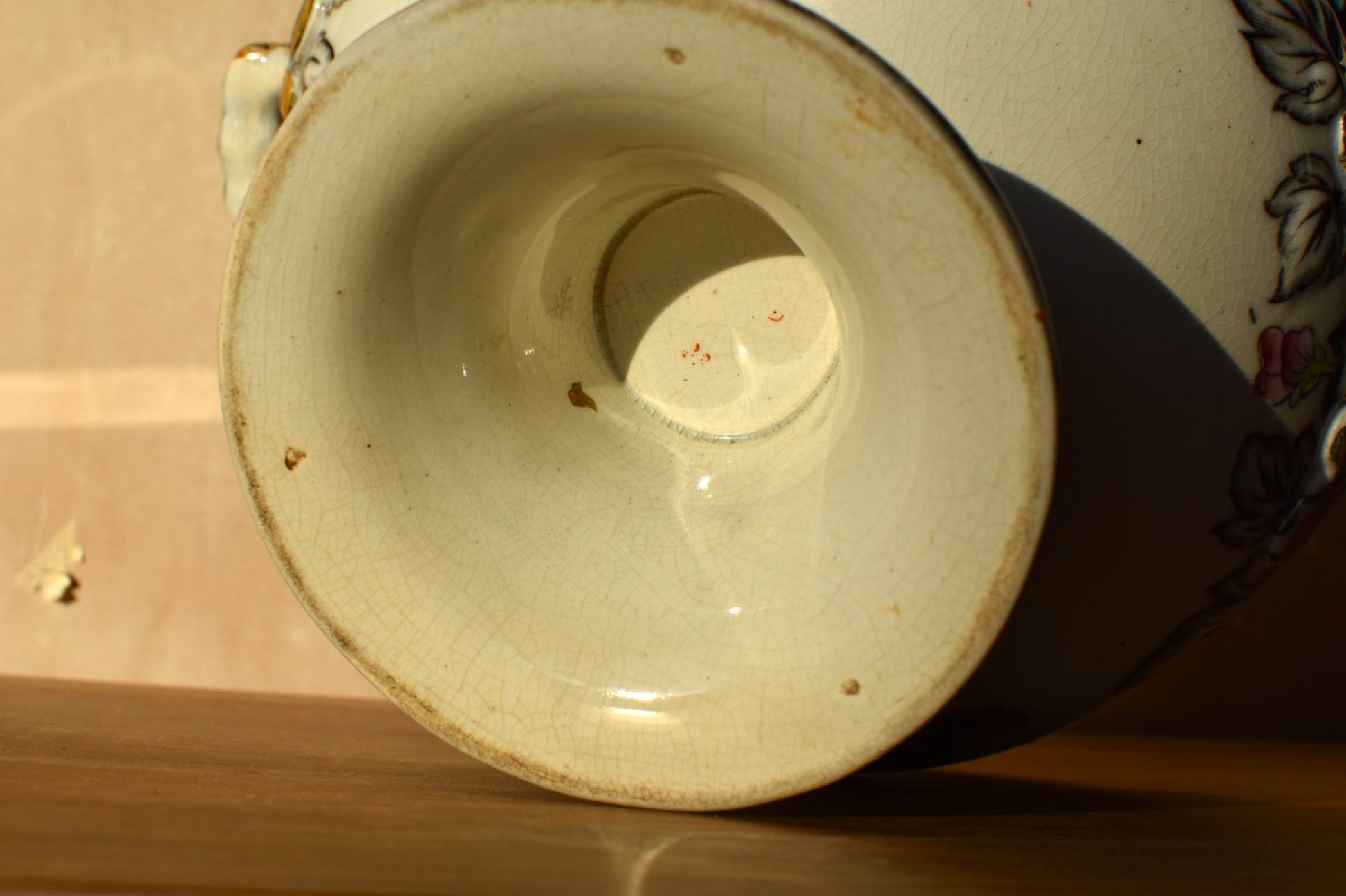 Close-up of a ceramic bowl's base on a wooden surface