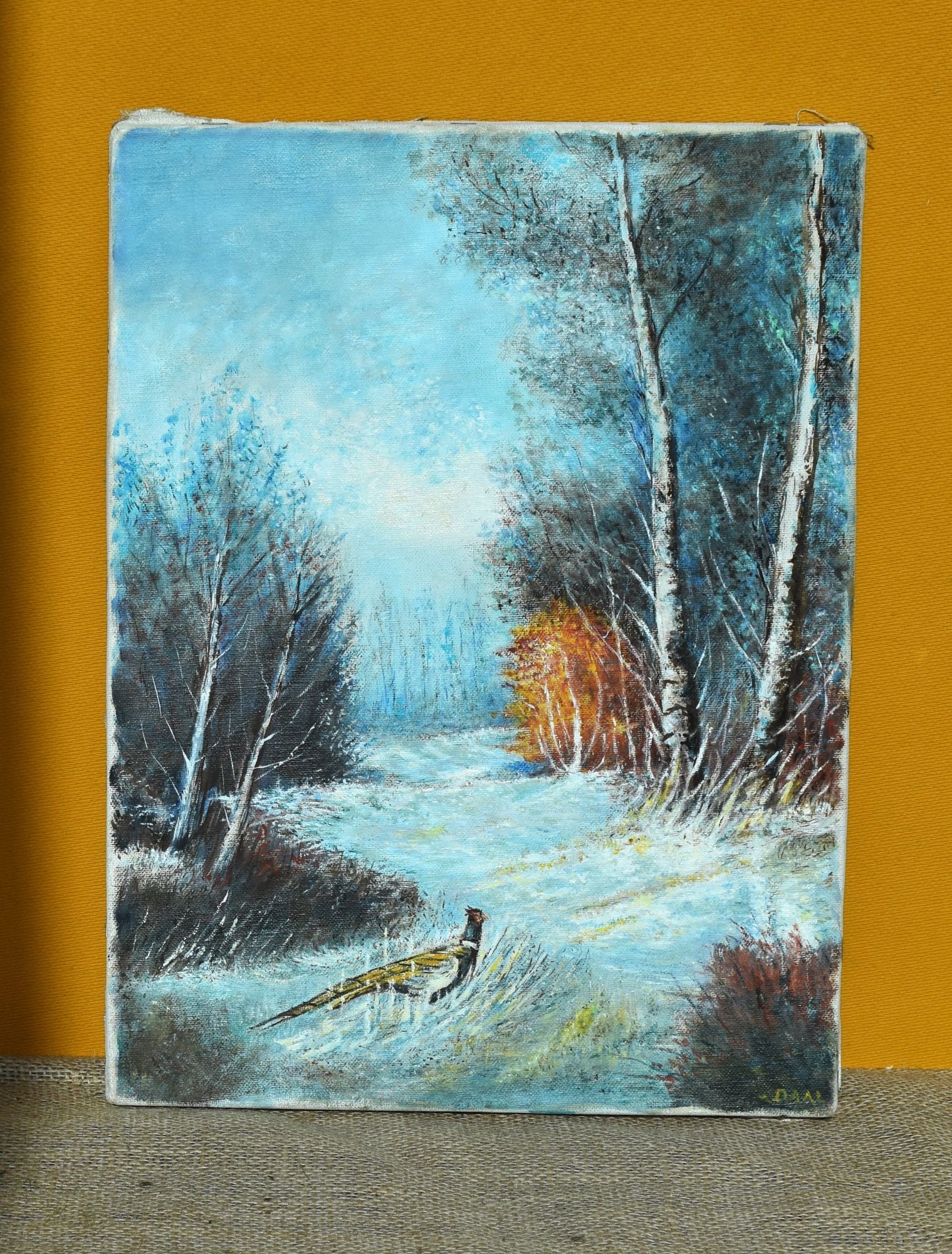 Oil painting of a snowy landscape with trees and a pheasant, on a textured canvas surface.