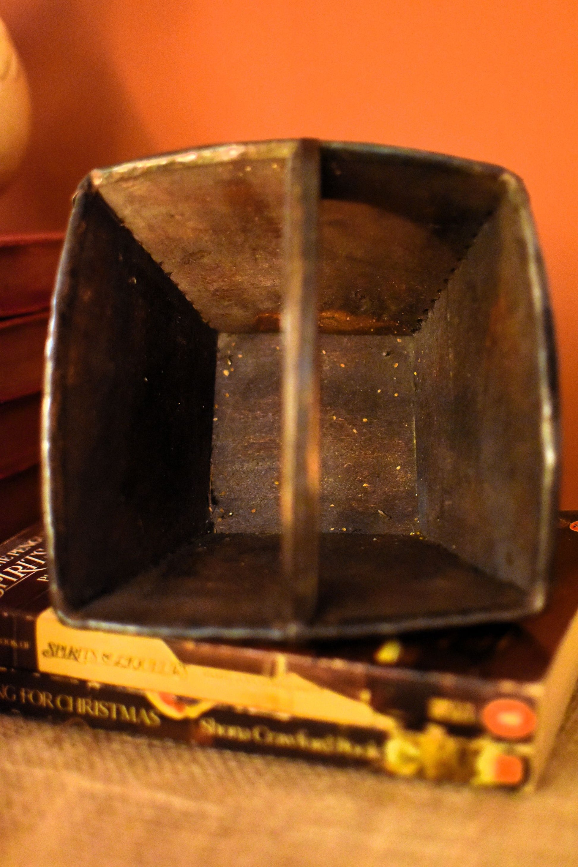 Wooden container on top of a book with a clean interior