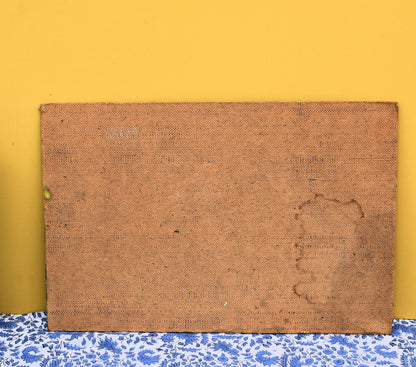 Brown textured board on a yellow wall with a blue floral-patterned baseboard.