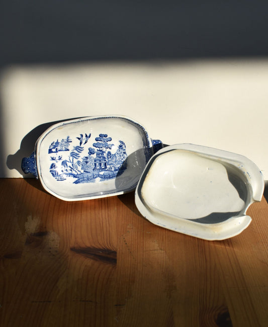 Blue and white ceramic butter dish on a wooden surface