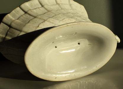 Close-up of a ceramic vase with textured surface and visible imperfections.