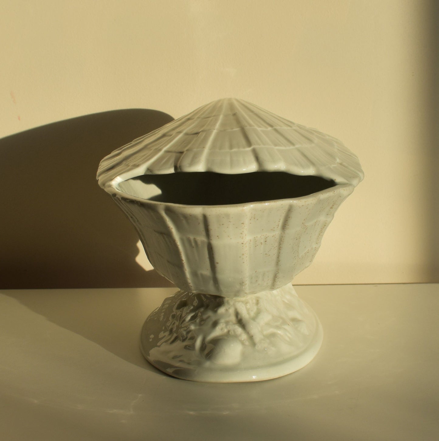 Decorative ceramic vase with textured surface on a plain background