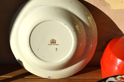 Ceramic plate with a visible brand logo on a wooden surface