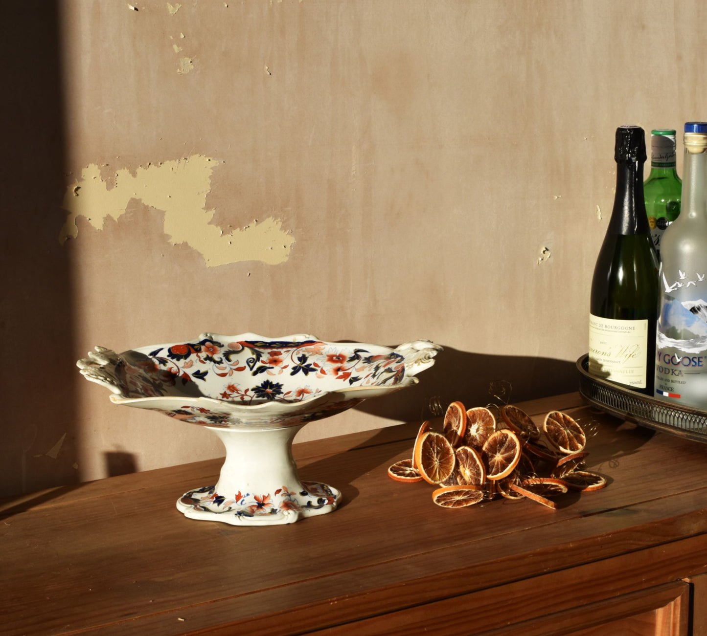 a floral raised dish on a wooden table